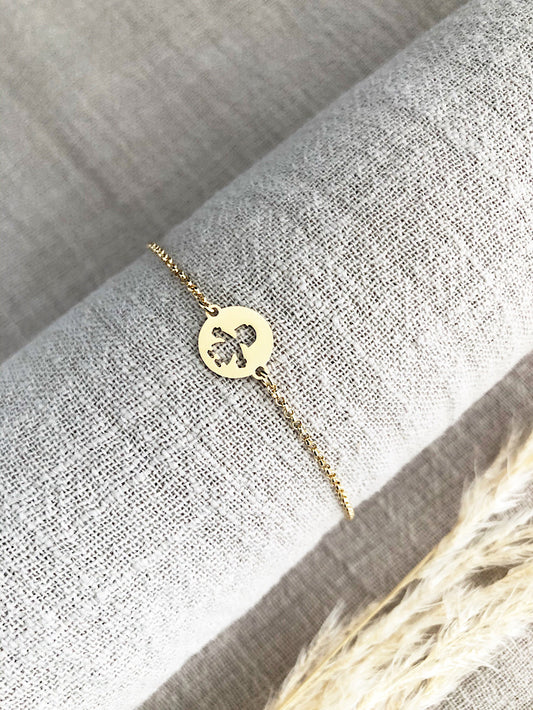 Pulsera cadena con dije círculo con niño calado