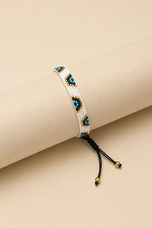 Pulsera tejida miyuki 6 filas blancas con ojos turcos blanca