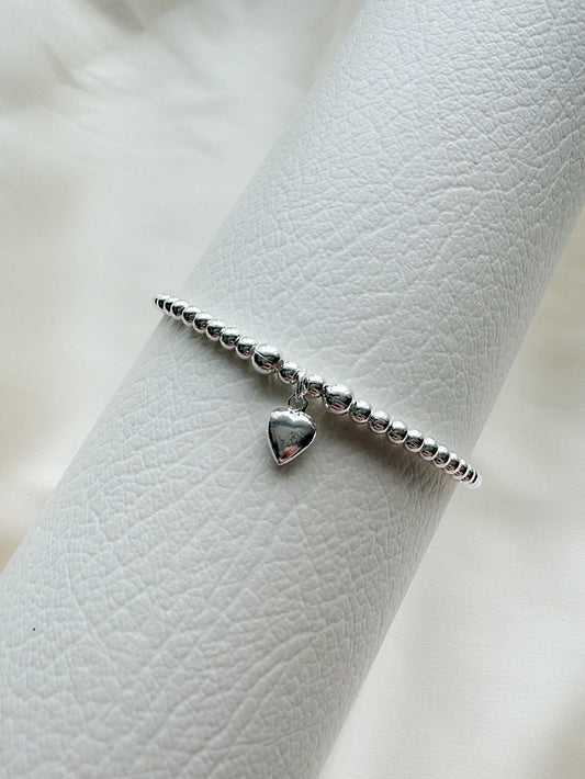 Pulsera regulable bolitas con dije corazón colgando