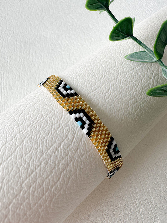Pulsera tejida miyuki 6 filas doradas con ojos turcos