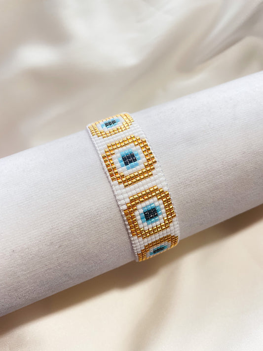 Pulsera tejida miyuki 11 filas blanca con ojos turcos